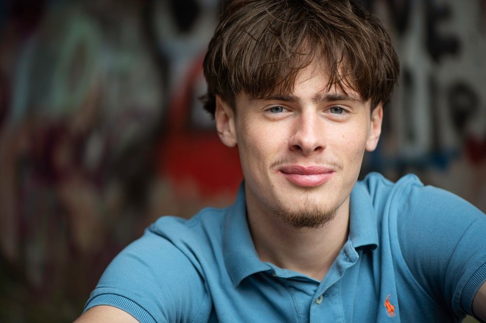 A collage of portrait photos showing someone in a blue shirt against various backgrounds.