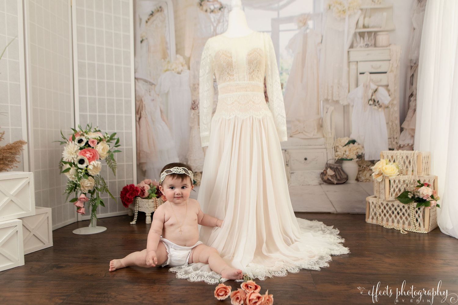 Elegant bridal boutique interior with white wedding dresses, floral arrangements, and vintage-inspired decor.