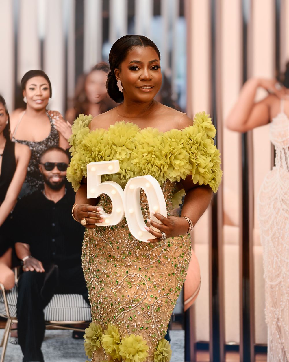 A stunning yellow ruffled gown with intricate beading sparkles at a formal event.