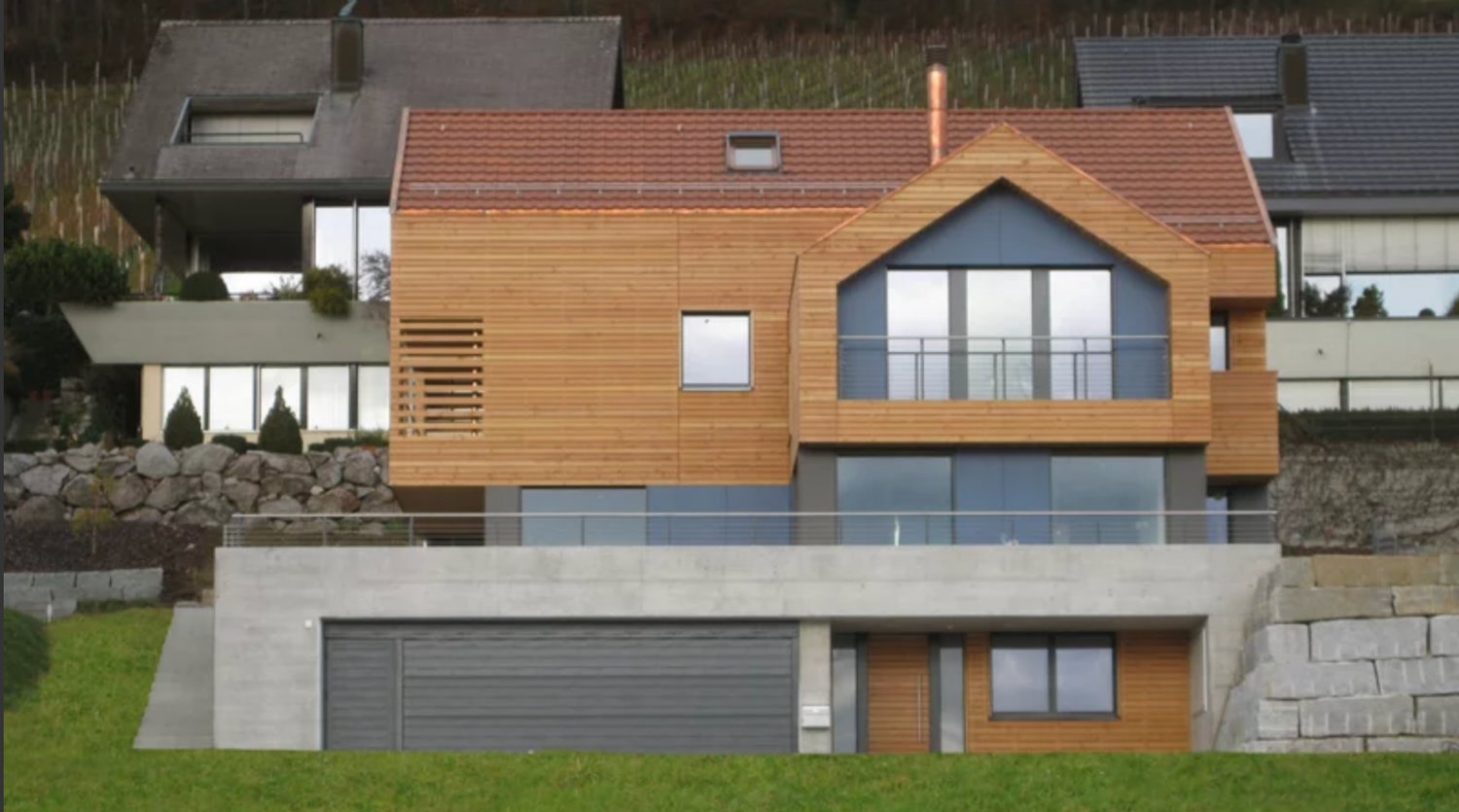Modern architectural design featuring multiple connected structures with wood paneling and glass windows in a panoramic view.