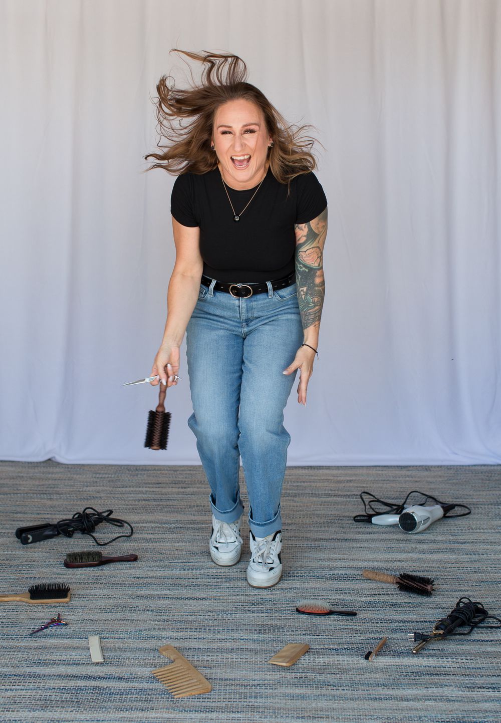 Series of playful poses showing figure with hair movement and styling tools on floor.