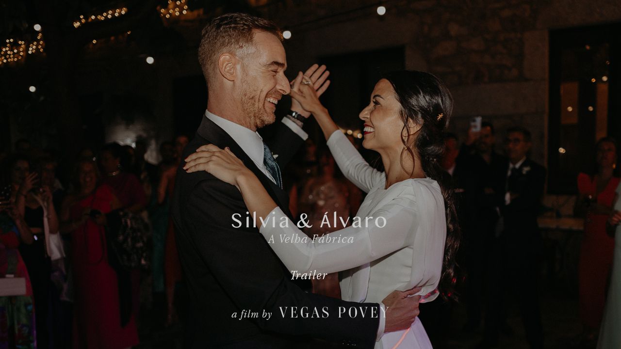 Joyful candid moment between newlyweds during their first dance at the reception.