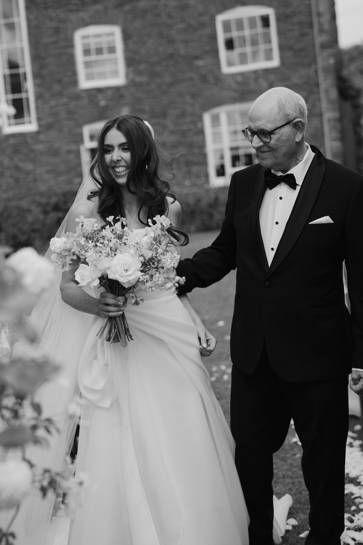 dad smiling at bride before he gives her away to the groom during the wedding ceremony at dewsall court in herefordshire