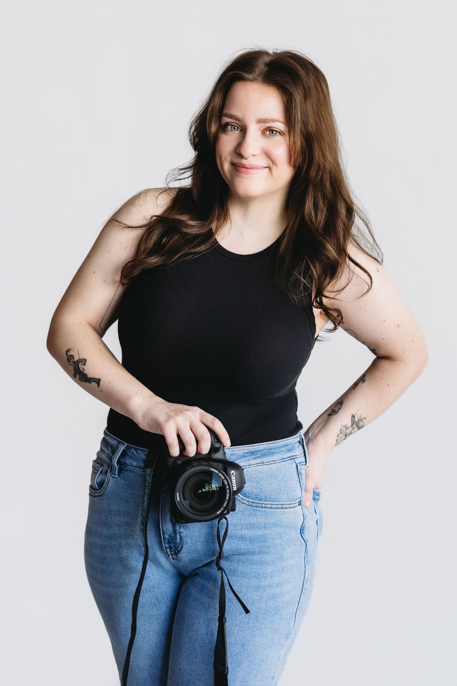 Person in black tank top and light blue jeans poses with camera against white background in four different poses.
