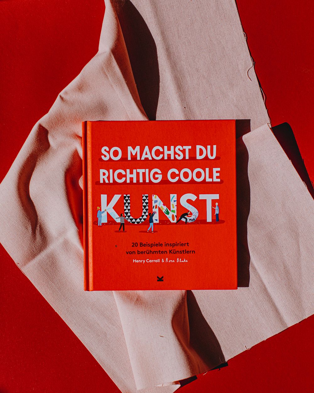 A series of red book covers with white text arranged in a minimalist style against a light background.