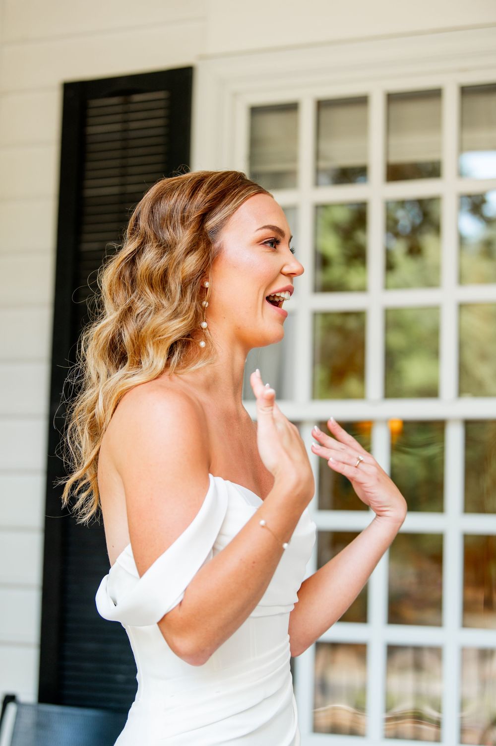 Joyful moment captured on white colonial style porch.