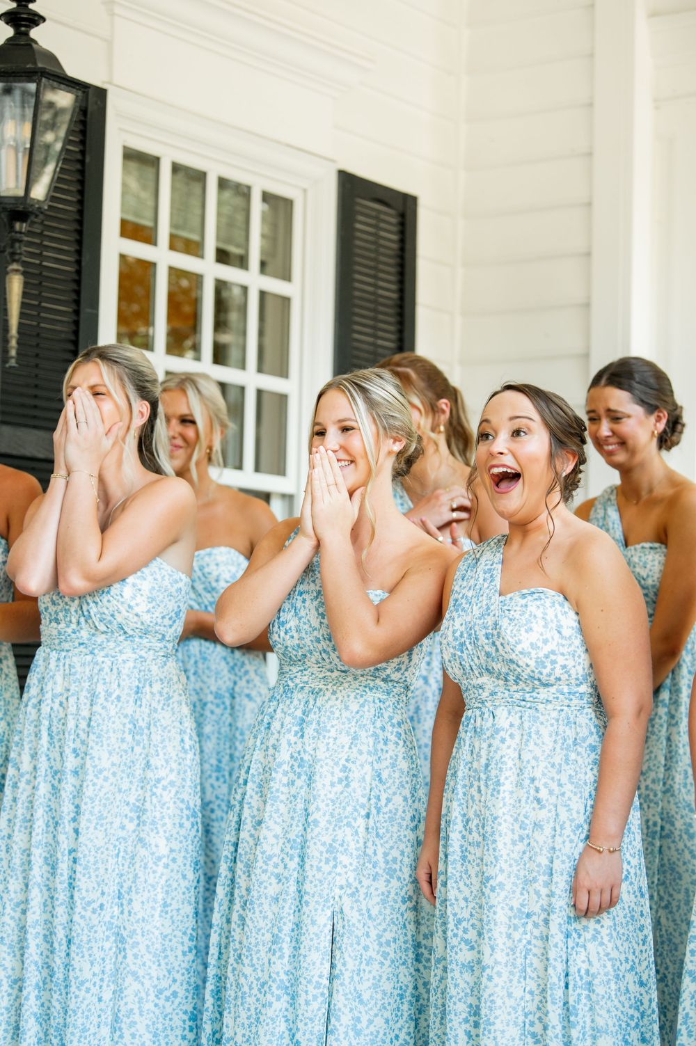 Bridesmaids in matching blue sequined dresses showing excited reactions.