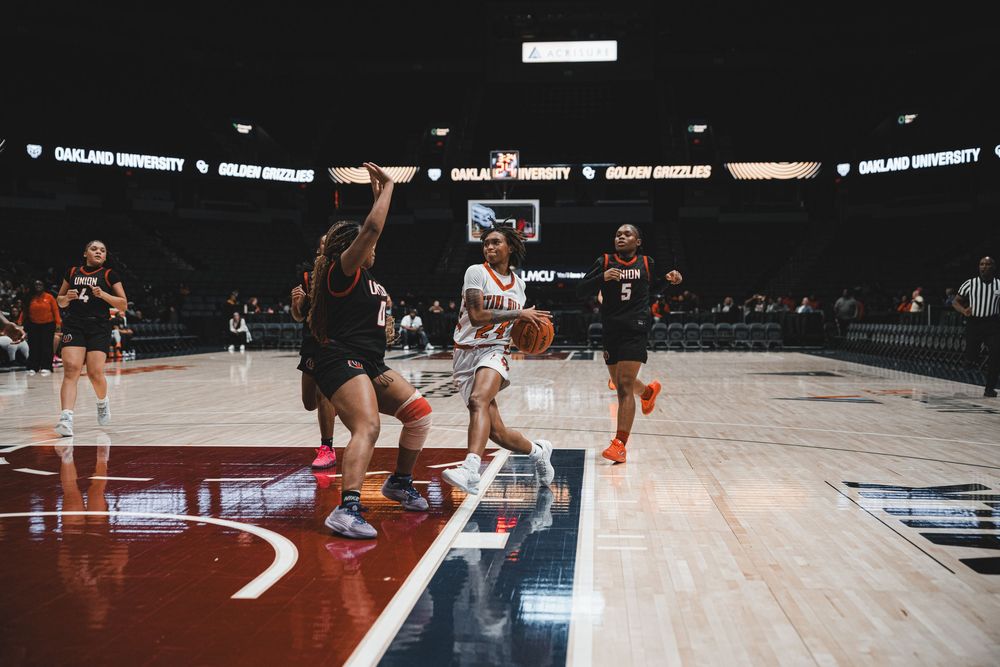 Basketball players battle for position during a competitive indoor game.