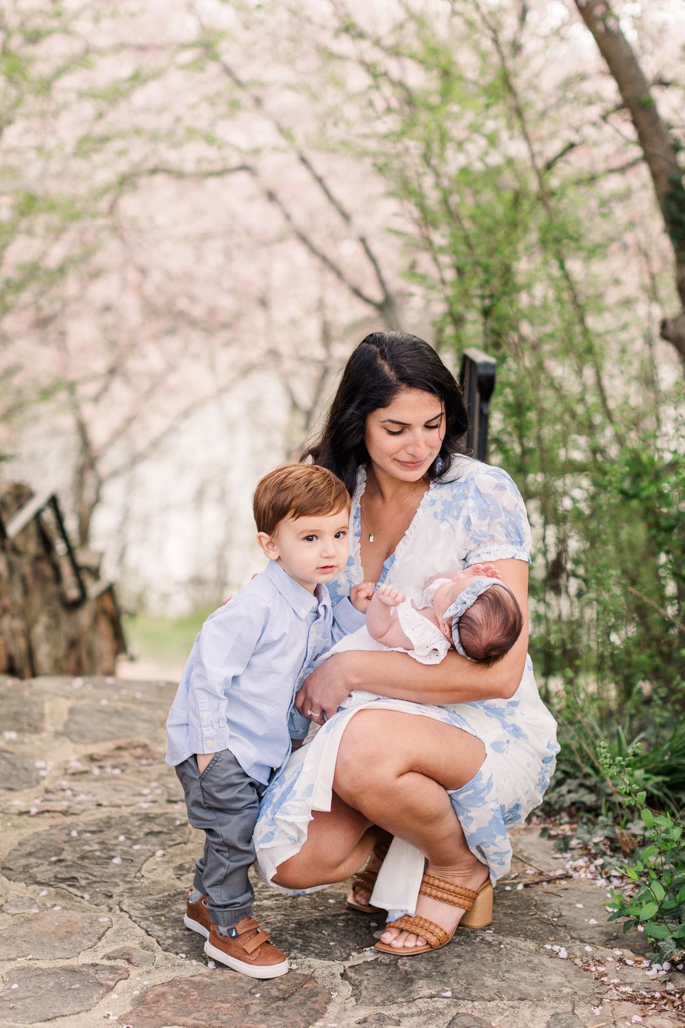Mom and kids smiling together among the Cherry blossoms for a photography mini session in RVA