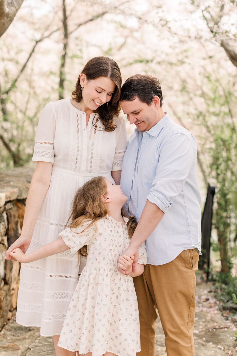 Parents smiling with their daughter during the spring at Midlothian Mines park in Chesterfield Va