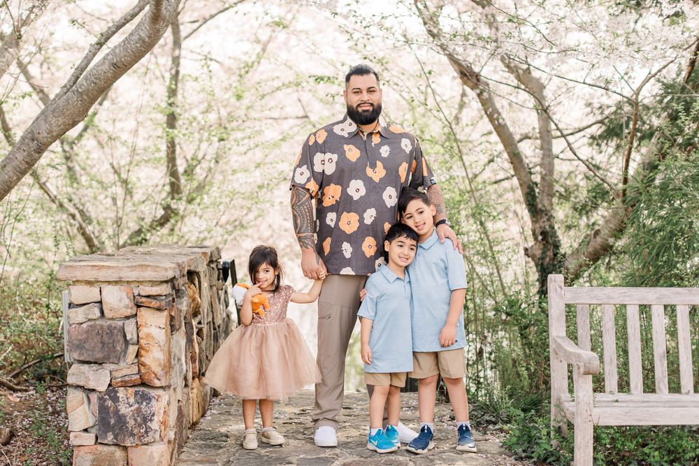 Father and kids smiling together during a Cherry blossom mini session in Richmond Virginia.