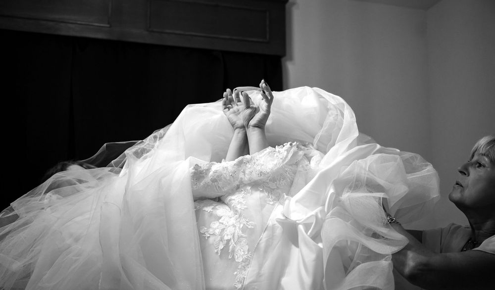 Black and white artistic detail shot of layered wedding dress fabric.