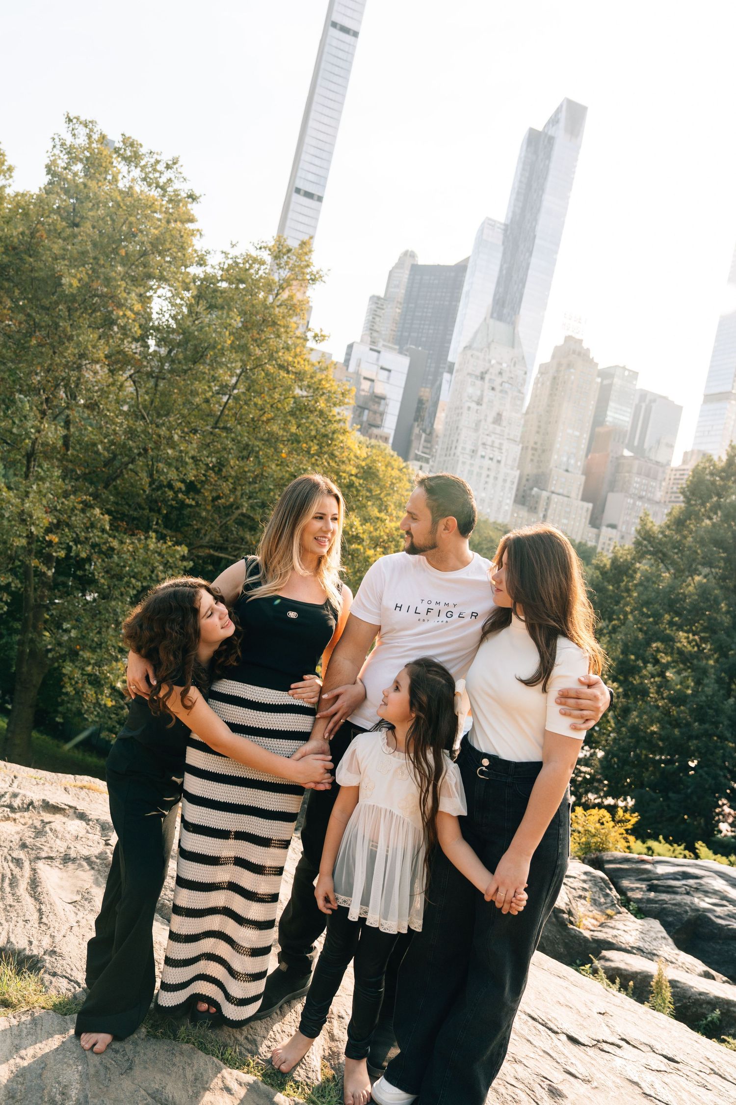 A series of casual photos taken in Central Park with the Manhattan skyline and fall foliage in the background.