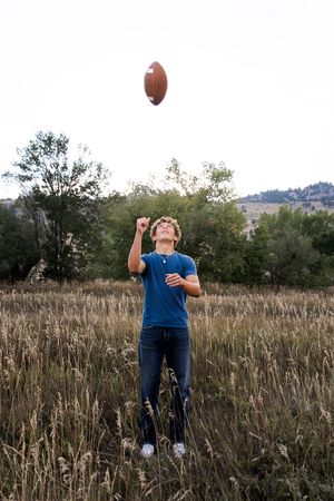 A sequence of four photos shows a person throwing a football in a grassy field at sunset.