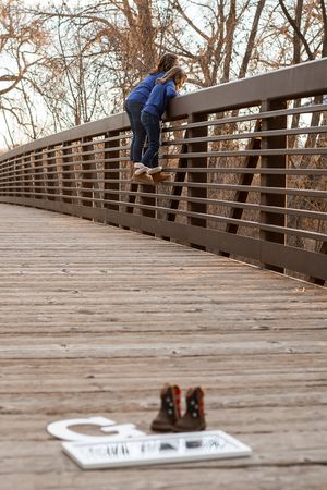 A sequence of photos showing a wooden bridge walkway with white paper signs laid out on the deck.