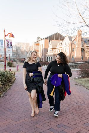 Two people in dark clothing walking together on a brick path, shown in a sequence of four connected photos.
