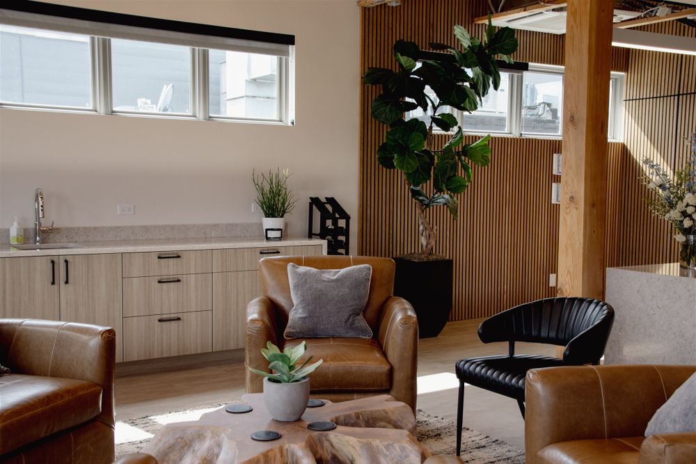Contemporary office lounge area with modern furniture and wood accent walls.