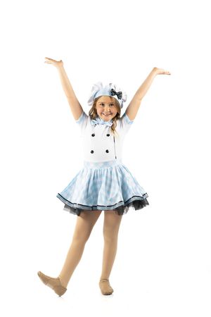 Young girl in blue and white dance costume with matching hat, arms raised joyfully, posing on white background.