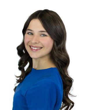 Four poses of person in royal blue top with dark wavy hair against white background.