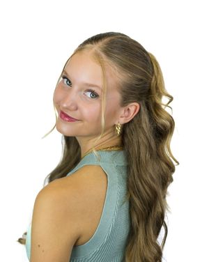 Person in turquoise top striking multiple poses with hands near face against white backdrop.