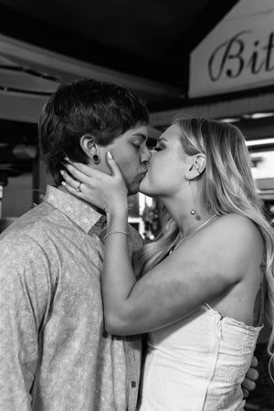 Black and white photo series showing a romantic sequence of people embracing and sharing an emotional moment.