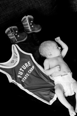 Black and white photo sequence showing a baby lying on their back wearing a 'Future Star' sports jersey.