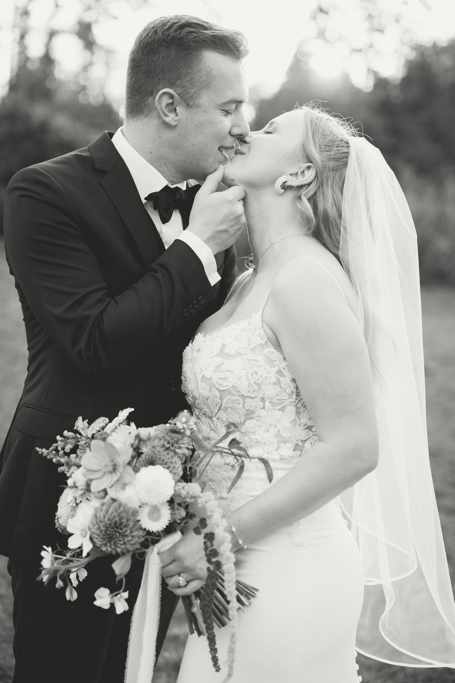 Black and white wedding photos show romantic moments between newlyweds with elegant bouquets and veils.