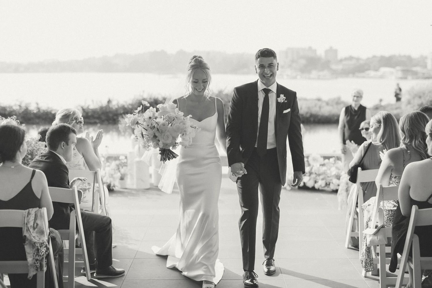 Black and white wedding ceremony processional captured in panoramic style.
