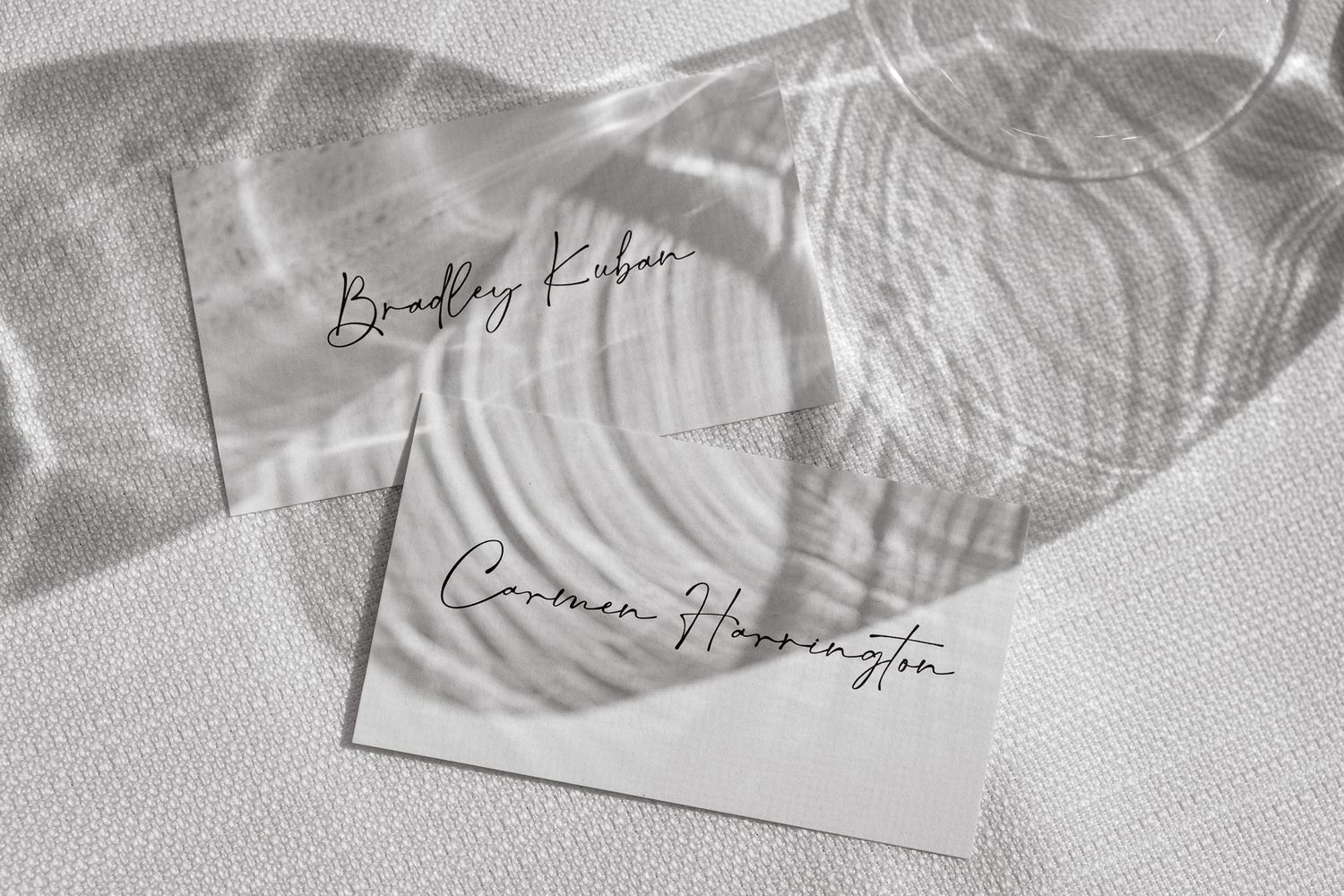 Close-up of elegant wedding stationery with calligraphy in black and white.