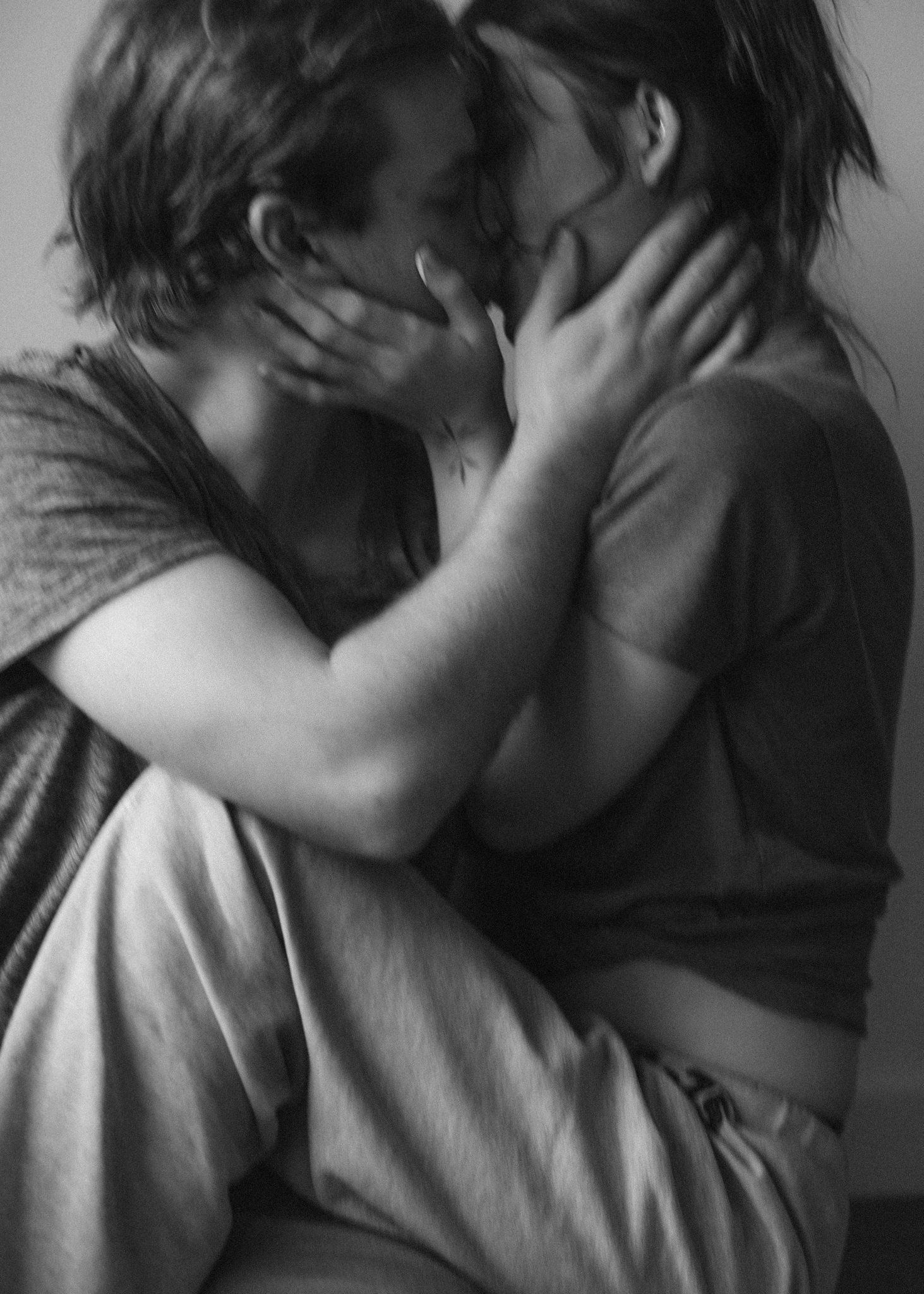 Intimate black and white artistic portrait showing tender embrace.
