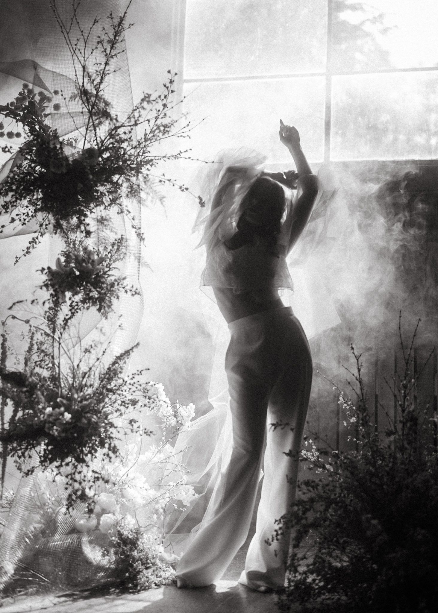 Dramatic black and white sequence showing silhouettes dancing through misty outdoor scenery.