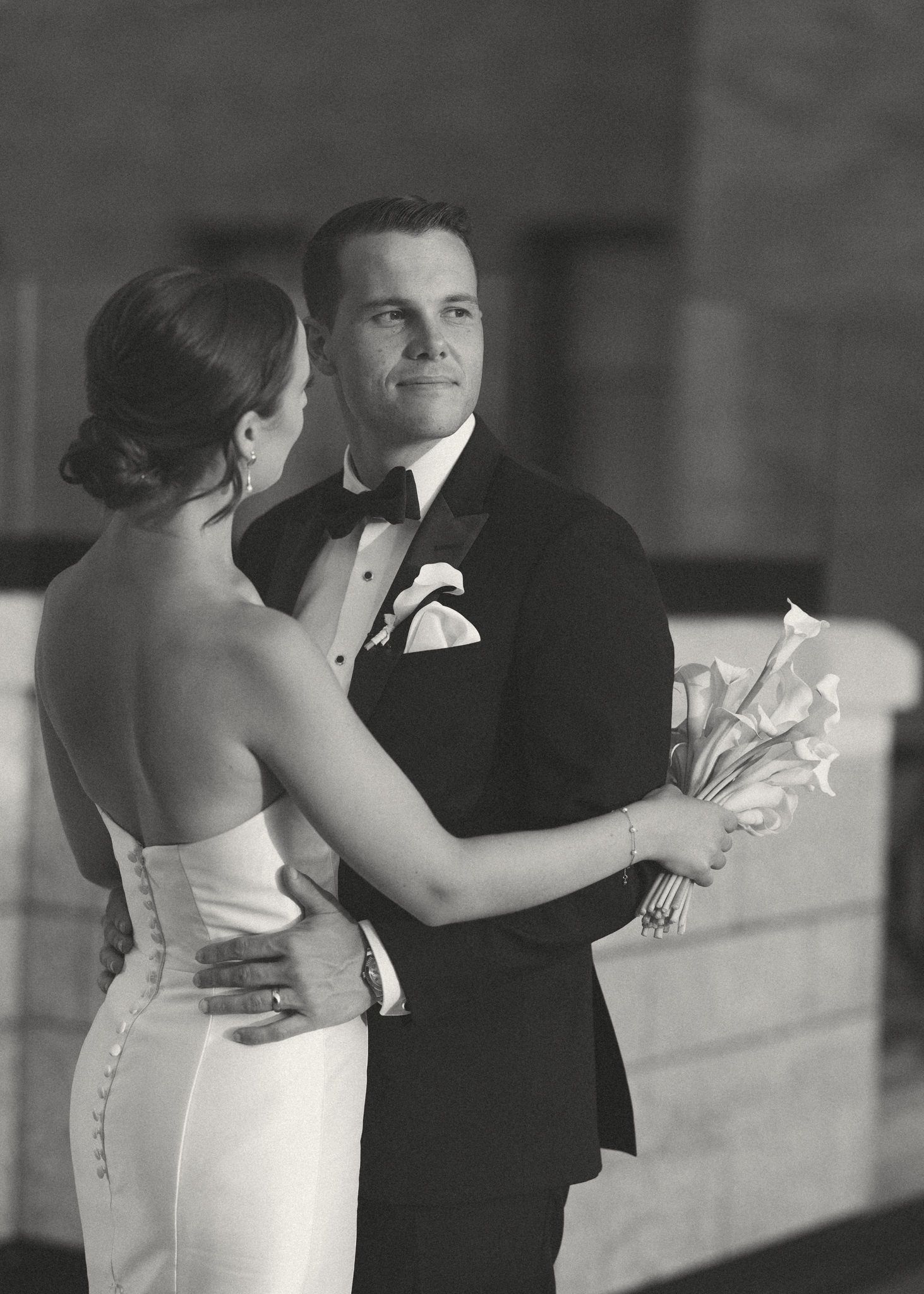 Couple dancing in formal attire at wedding reception.