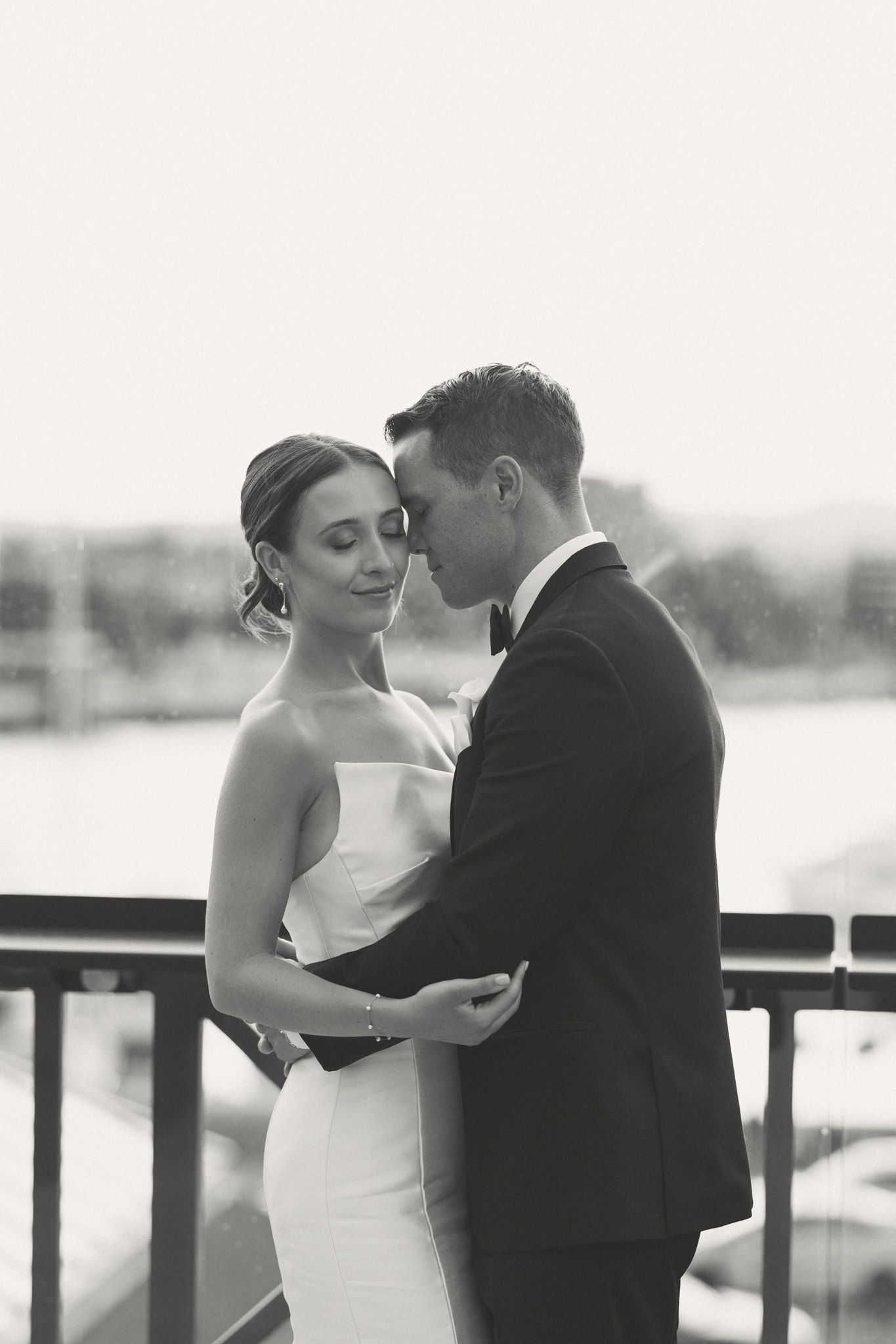 An intimate moment between newlyweds on an outdoor terrace.