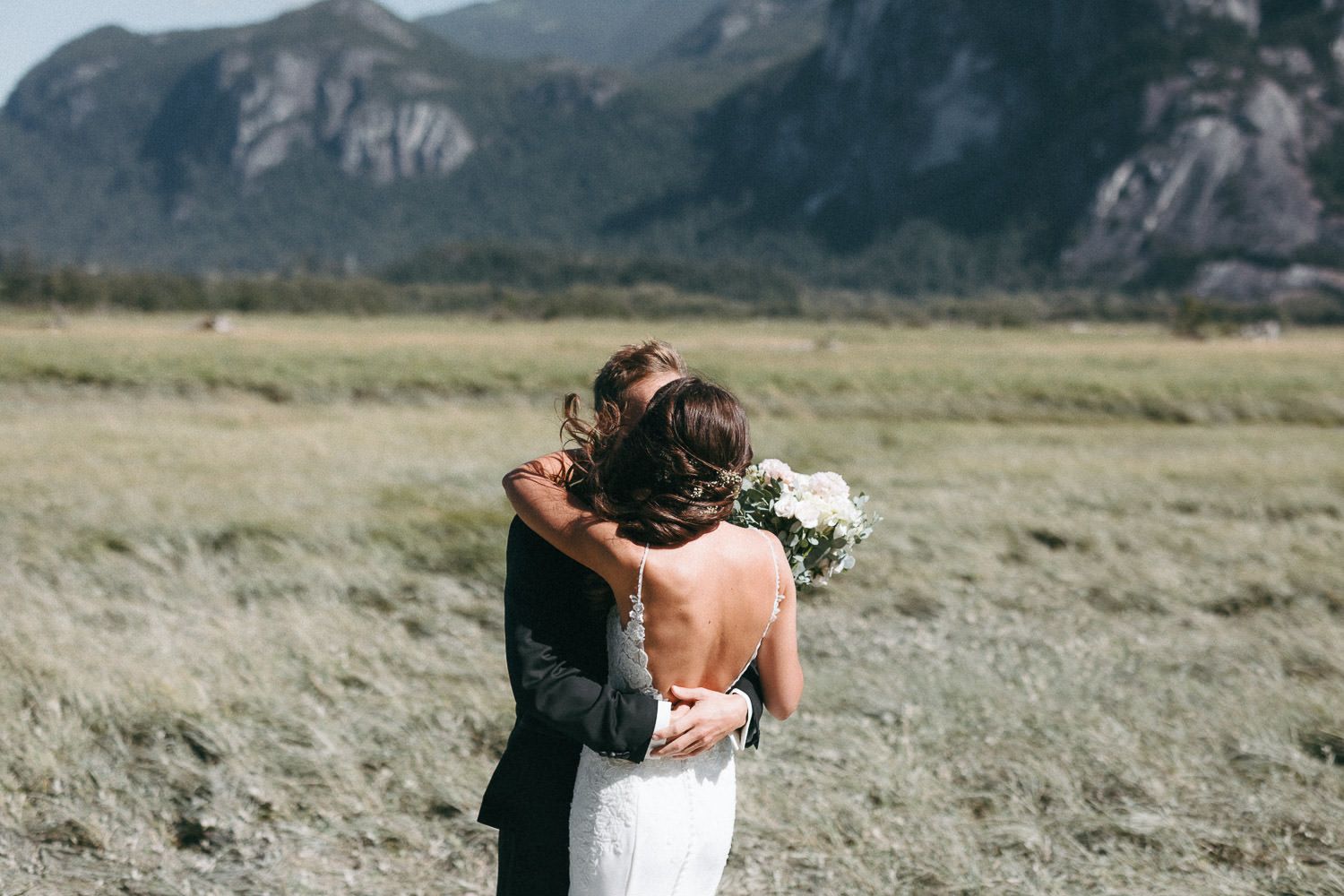 Romantic mountain wedding portraits with sweeping natural landscape.