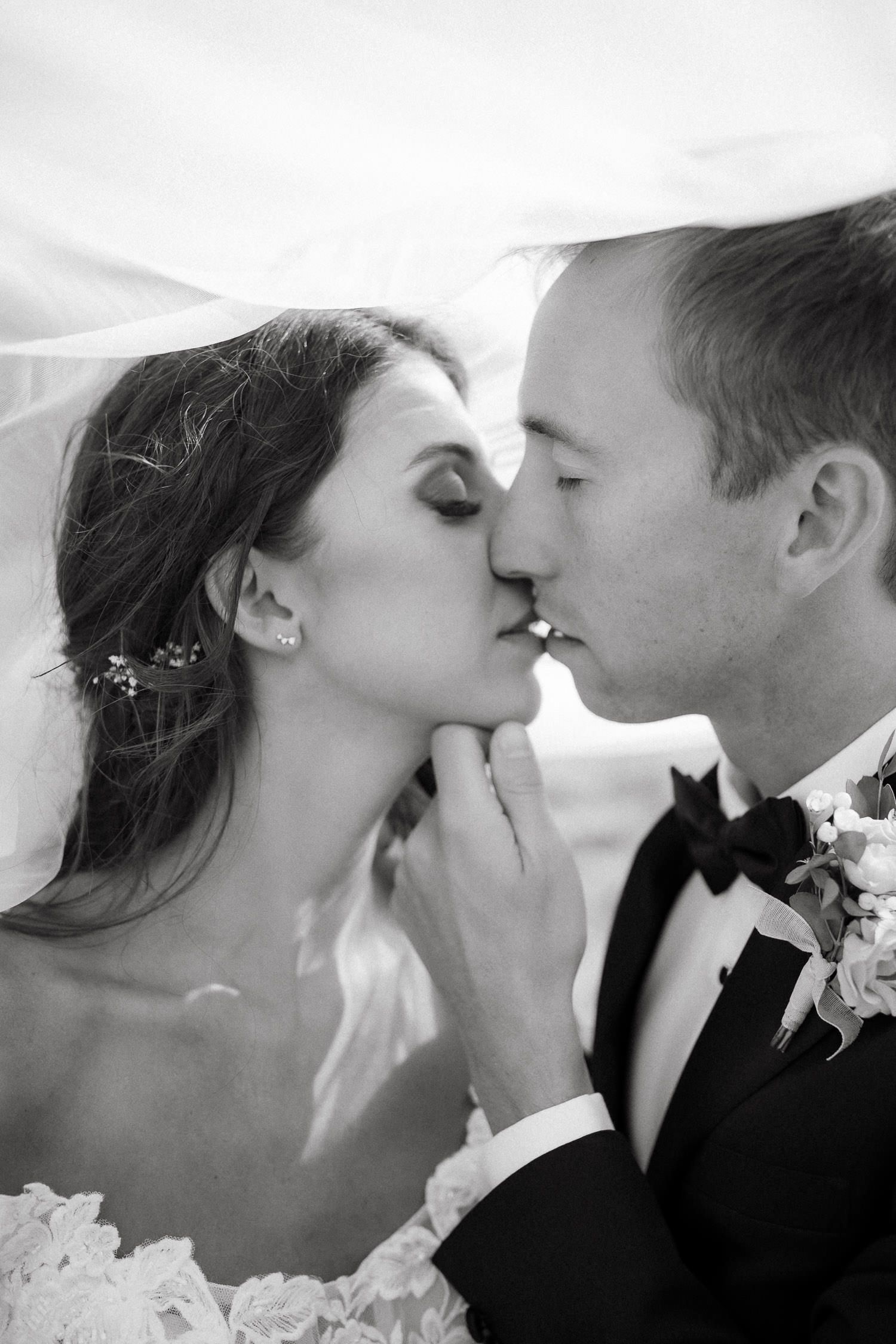 Intimate black and white wedding kiss sequence.