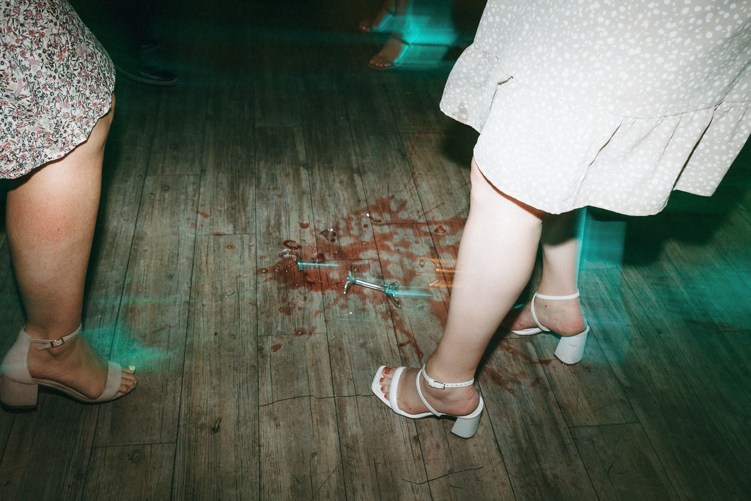 Detail shots of wedding shoes and dress hems on vintage wooden floor.
