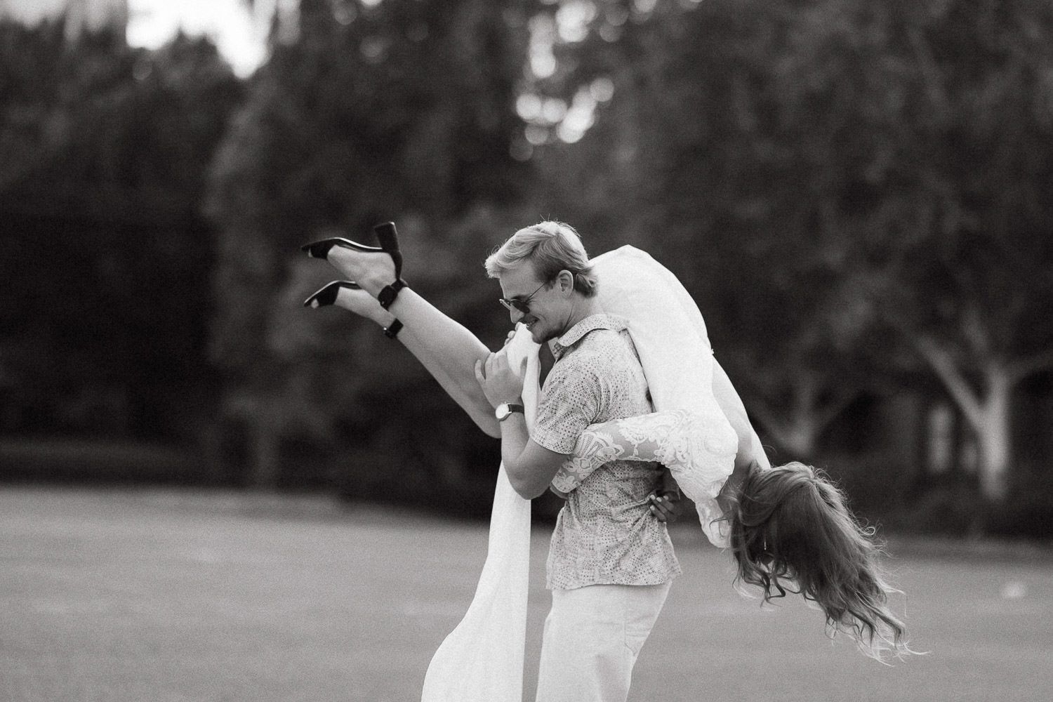Candid sequence of a couple dancing and spinning in an outdoor setting.