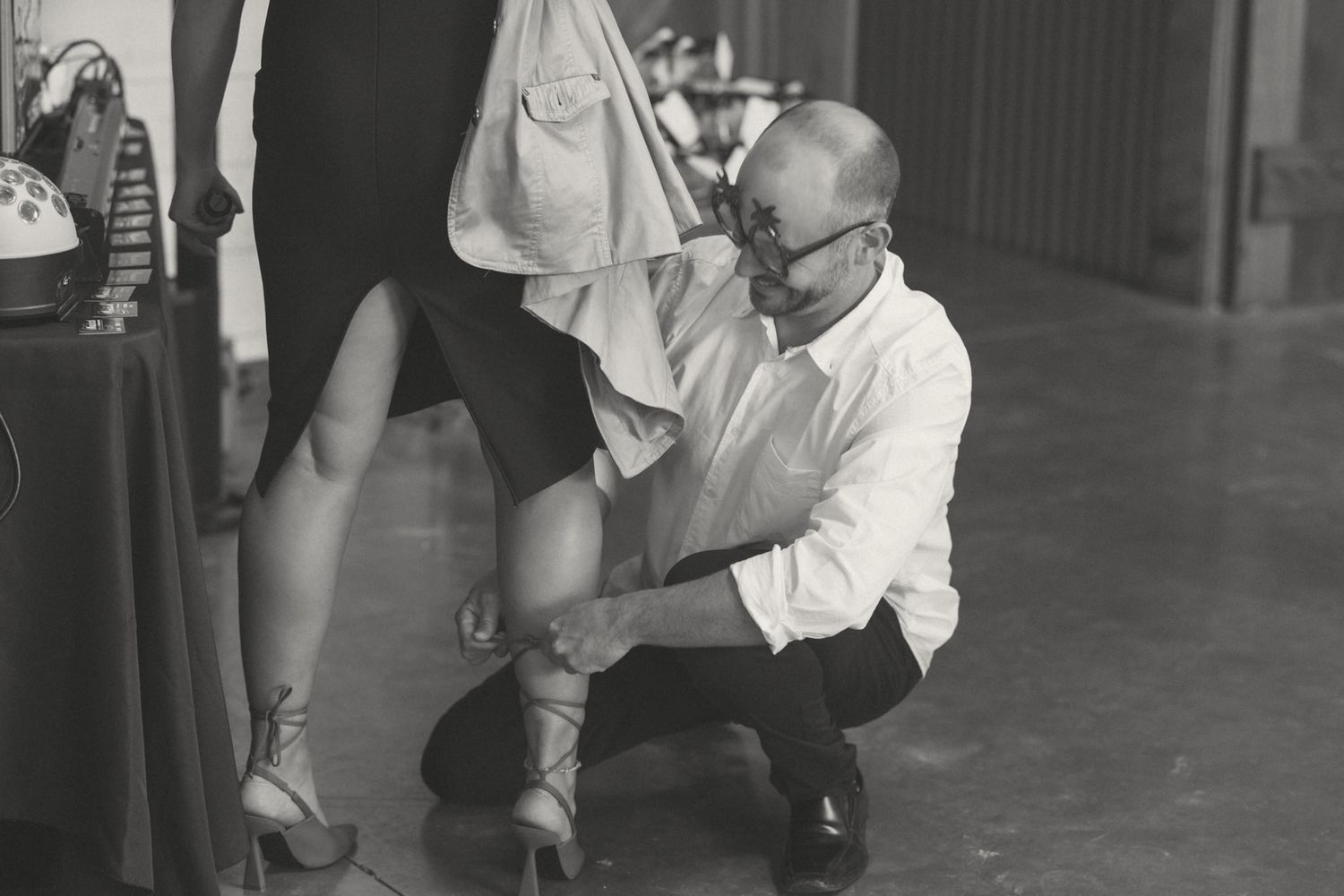 Vintage black and white photo of a dress fitting session.