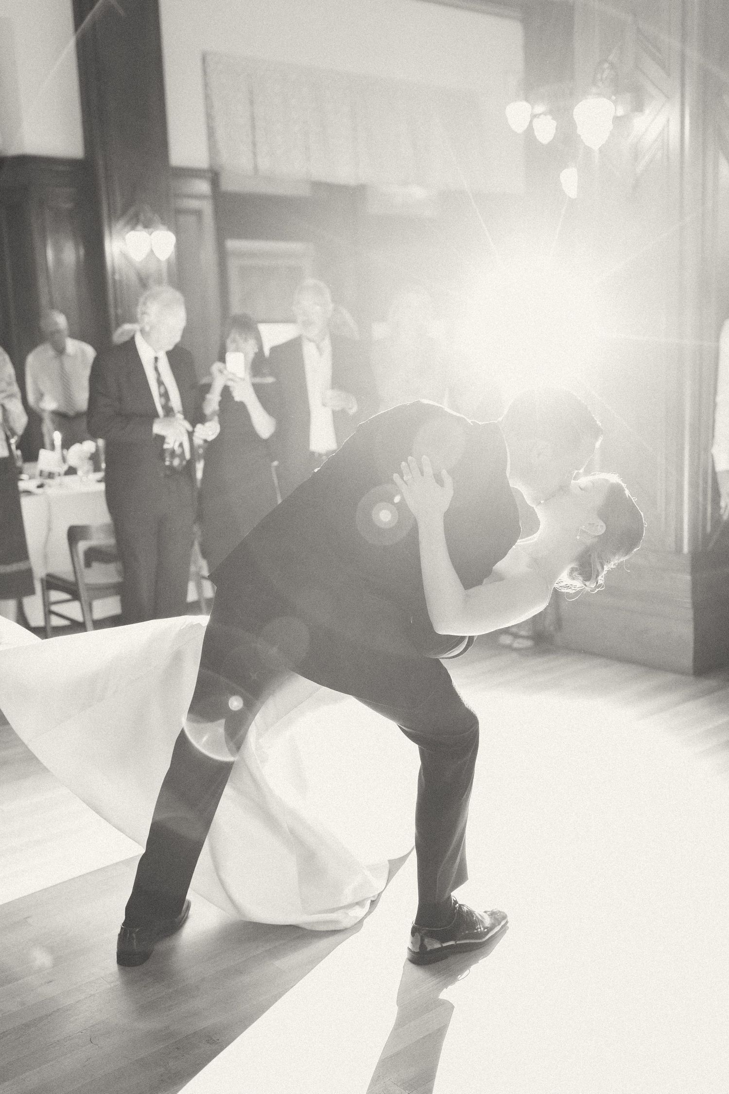 Black and white photo of bride and groom dancing in the Fairmont Empress Bengal Room.