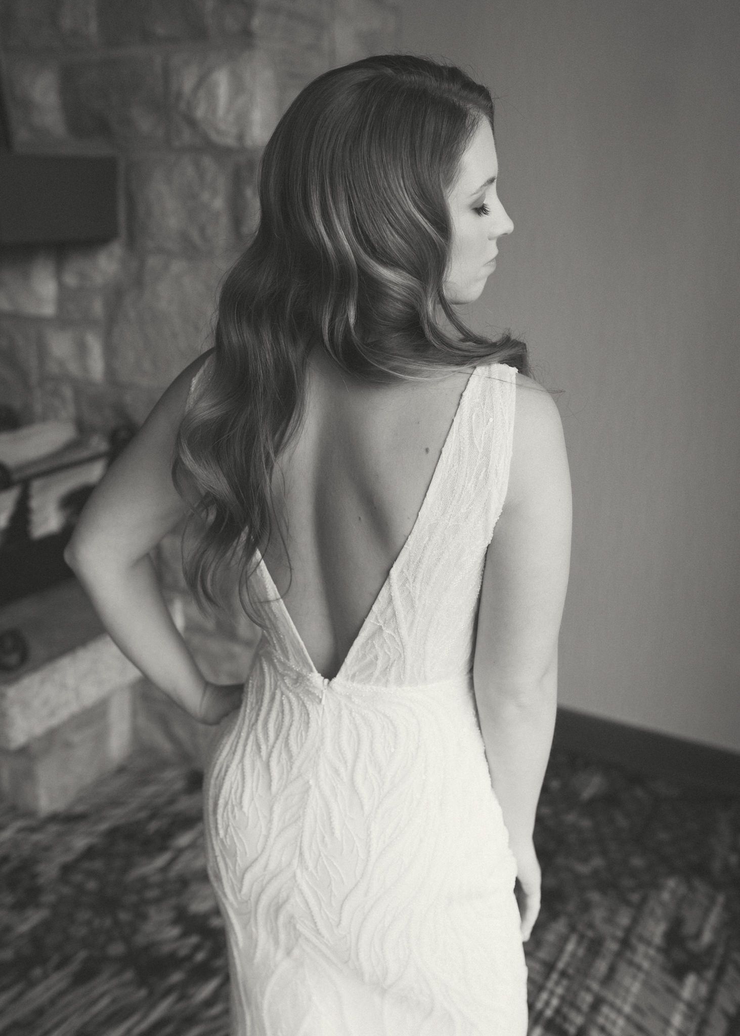 Back view of white lace wedding dress showing intricate textured details.