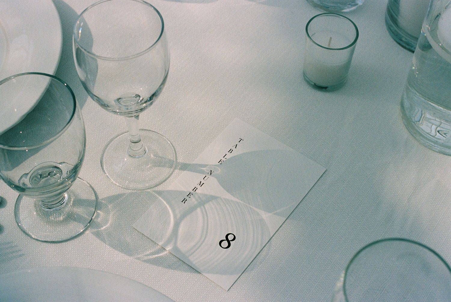 Empty wine glasses arranged on a table at a formal event.