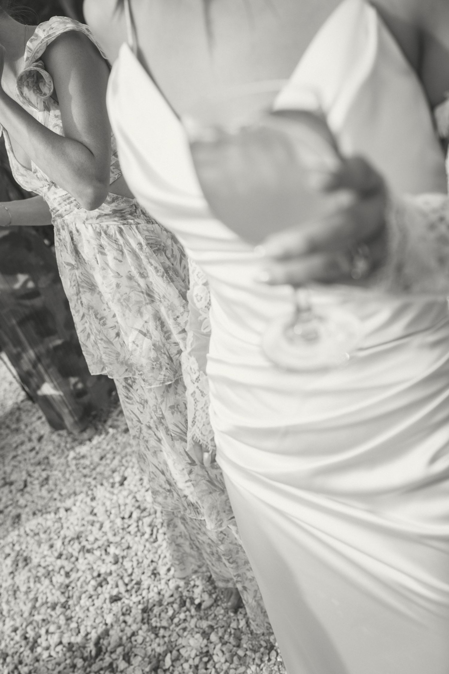 Close-up black and white detail shot of delicate lace wedding dresses with intricate patterns.