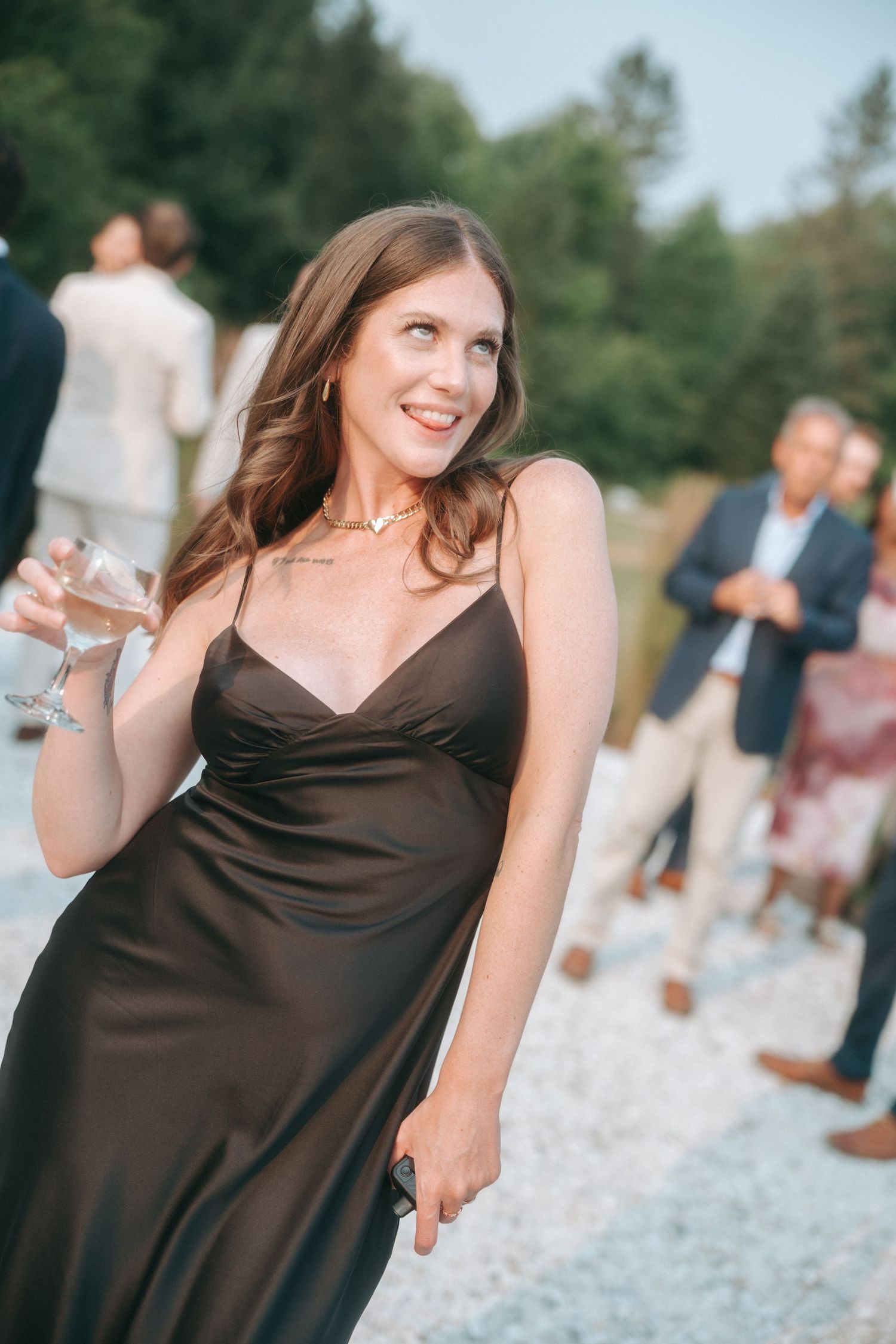 A sequence of photos showing someone in a brown dress dancing and twirling at an outdoor event.