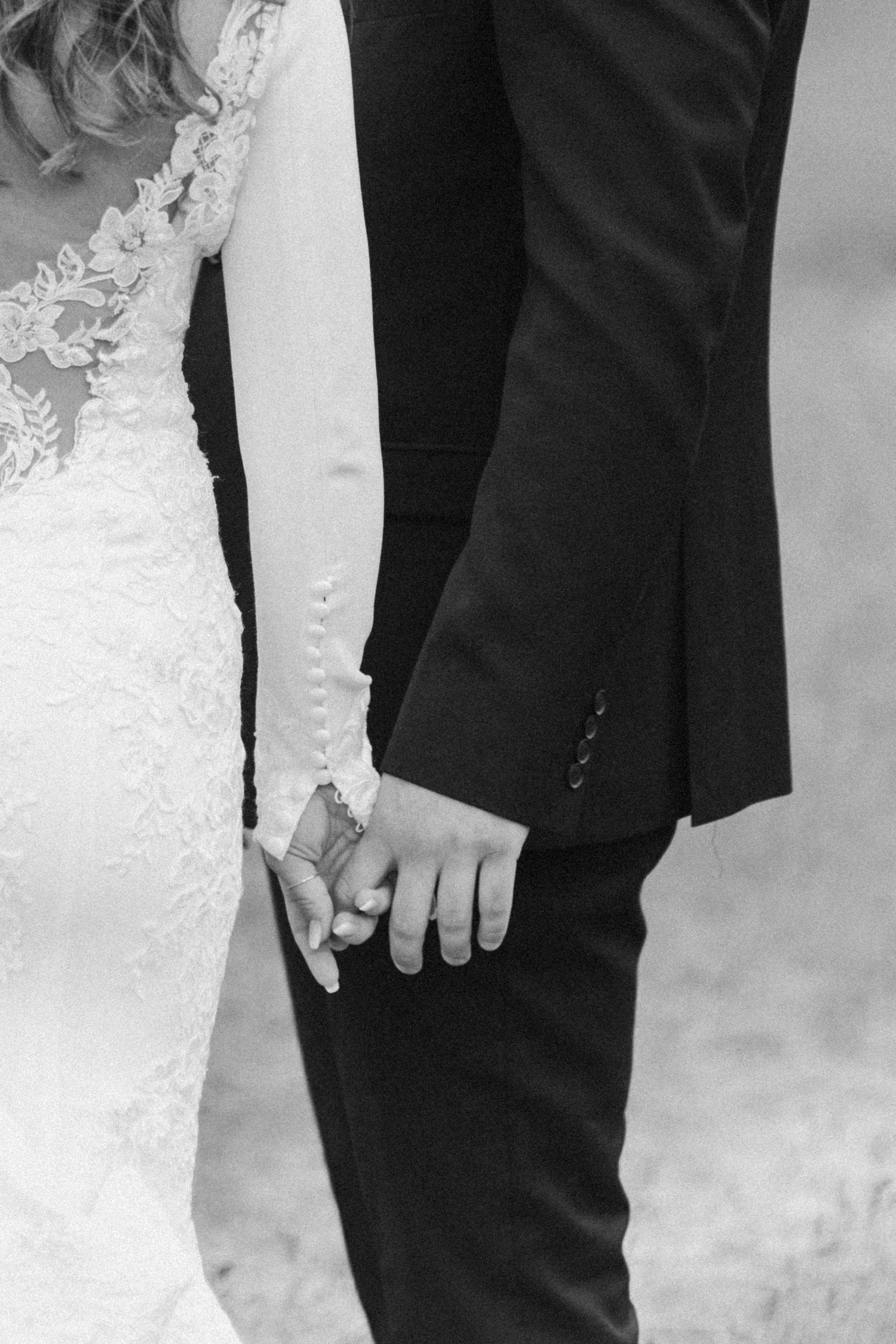 bride and groom holding hands
