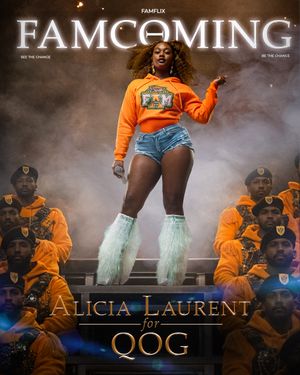 Performers on stage with orange outfits and mint green accessories create dynamic show with atmospheric smoke effects.