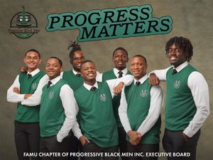 Group photo of board members wearing matching green vests and white shirts.