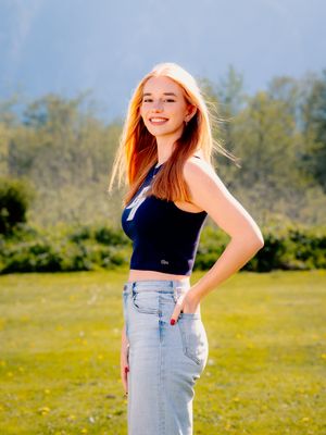 Casual outdoor fashion photography in denim and crop tops with golden hour lighting.