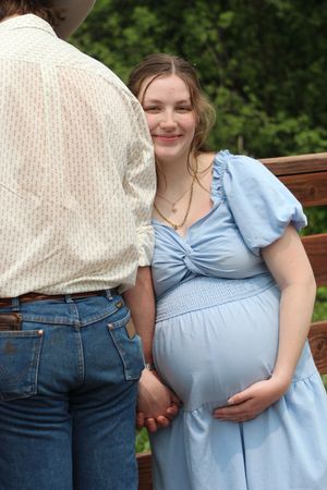 A progression of four maternity photos showing a growing baby bump in a light blue dress against an outdoor background.