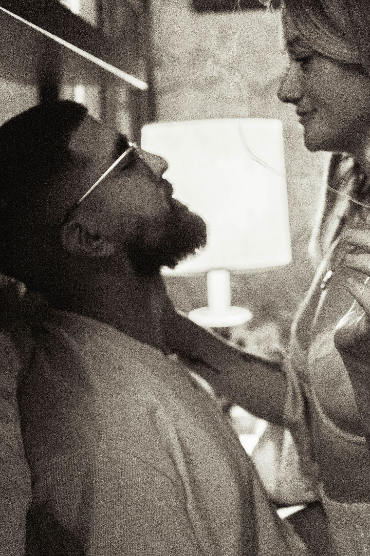 An intimate black and white portrait showing tender affection between two people.