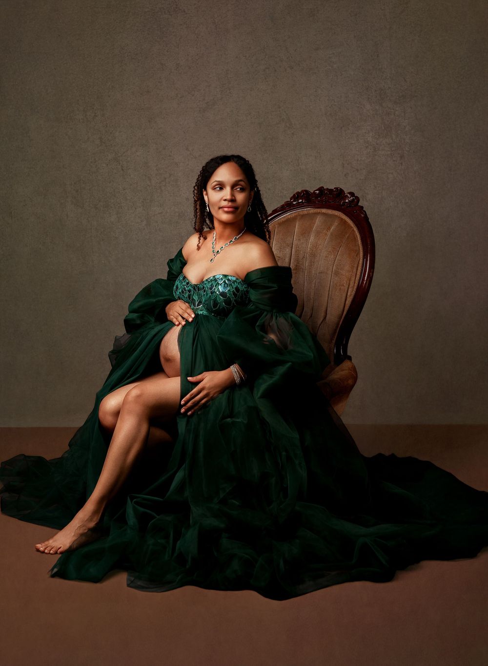 A series of artistic portraits showing a figure in an elegant emerald green dress reclining on a wooden chair against a dark backdrop.